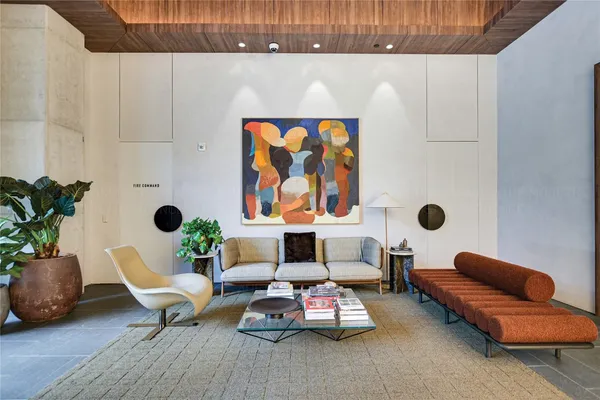 a living room with furniture and a potted plant