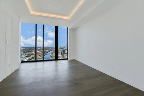 an empty room with large windows