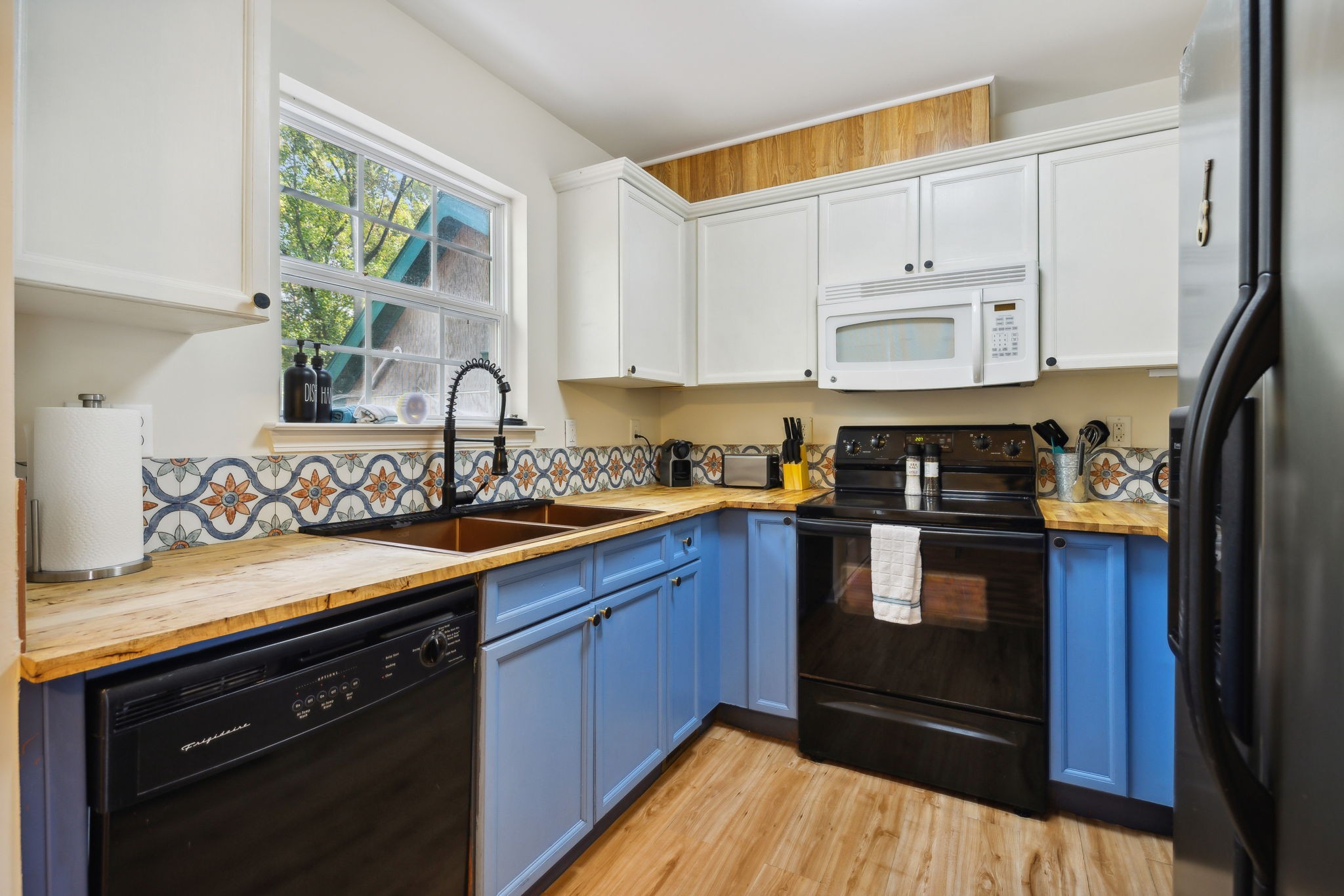 3908 Taylor Road Nashville, TN 37211 - Photo 12 of 42 a kitchen with stainless steel appliances granite countertop a stove a sink dishwasher and cabinets with wooden floor