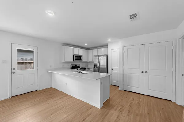 a view of a kitchen with wooden floor
