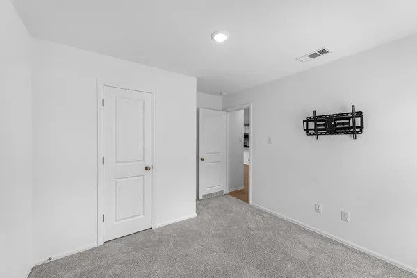a bathroom with a bathtub shower sink vanity mirror and toilet