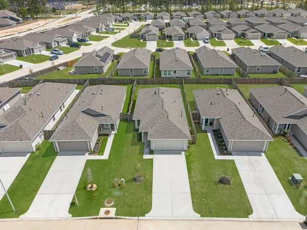 an aerial view of residential houses with outdoor space
