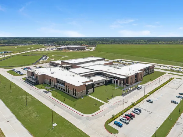 an aerial view of a pool patio kitchen and outdoor seating