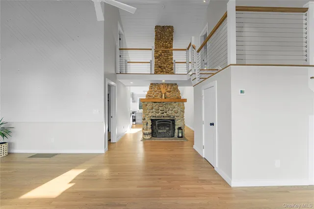 a kitchen with granite countertop a refrigerator and a wooden floor
