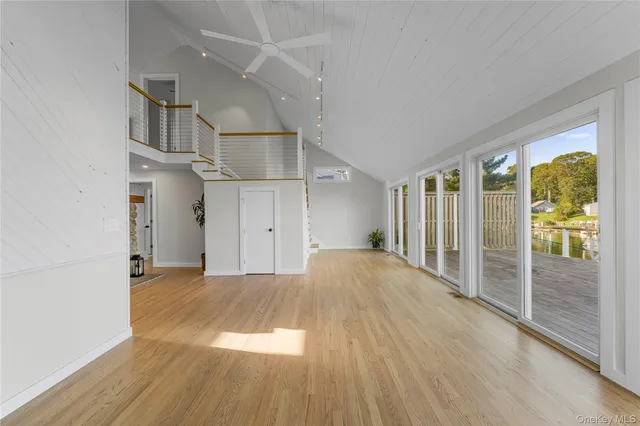 an empty room with large windows