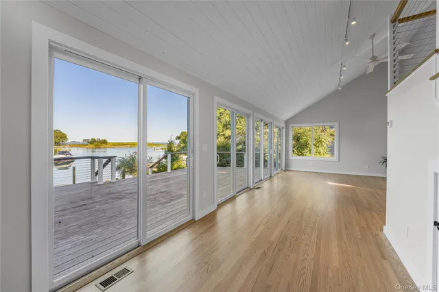 a view of hallway with livingroom and wooden floor