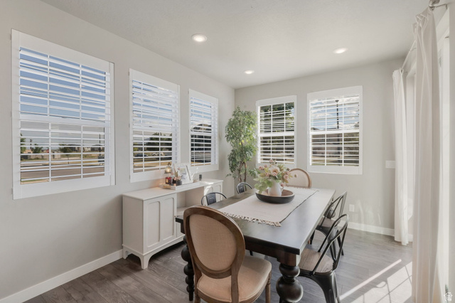 2319 North 3370 West Lehi, UT 84048 - Photo 6 of 30 Dining area featuring five windows with white plantation shutters, recessed ceiling lighting, wood-finish flooring, and light gray wall paint