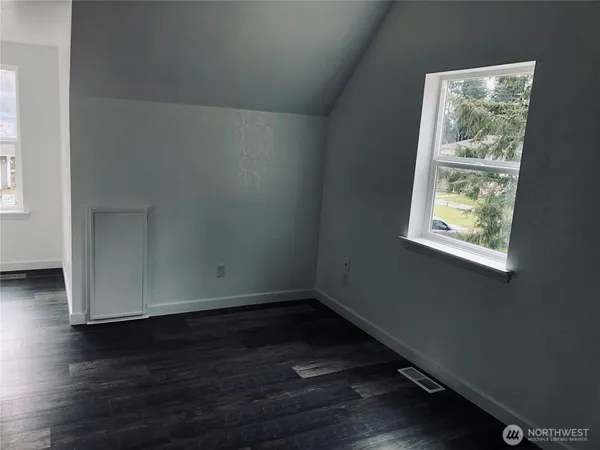 a bathroom with a granite countertop sink toilet and mirror
