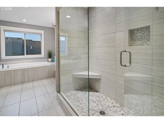 a bathroom with a glass shower door