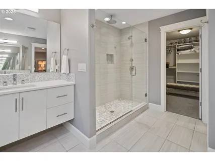 a bathroom with a shower sink and mirror