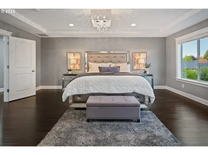a living room with a bed furniture and next to a window