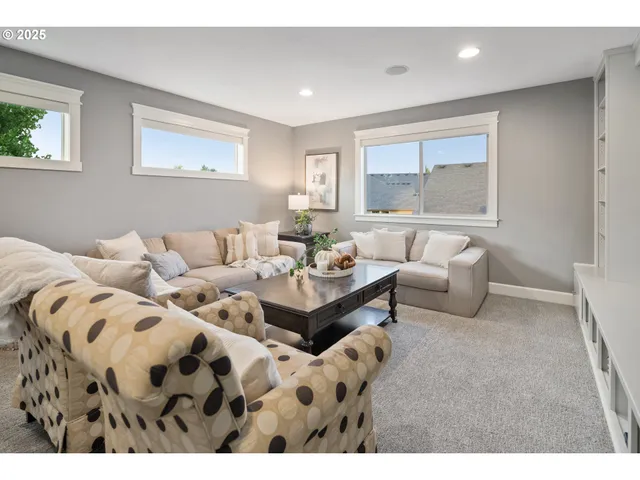 a living room with furniture and painting on the wall