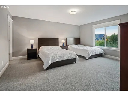 a bedroom with two beds and windows