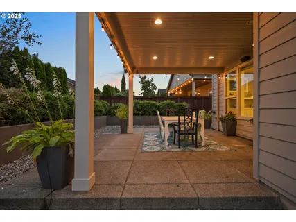 a view of a patio with a table and chairs and potted plants