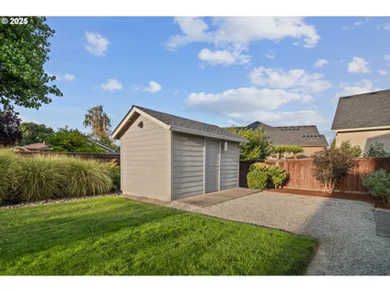 a backyard of a house with lots of green space and lake view