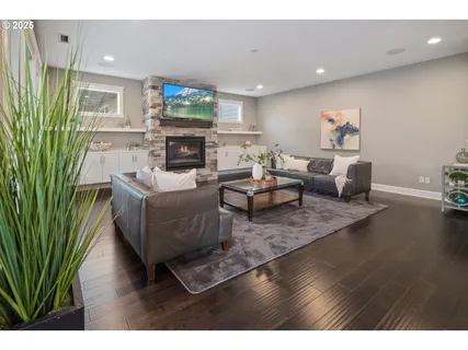 a living room with furniture a fireplace and a flat screen tv