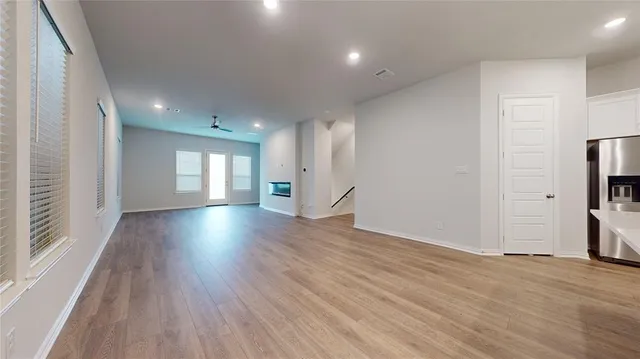 a view of wooden floor and windows in an empty room