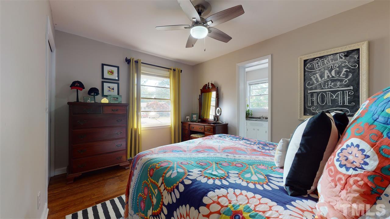 1001 Caspan Street Raleigh, NC 27610 - Photo 11 of 30 a bedroom with a bed and a dresser