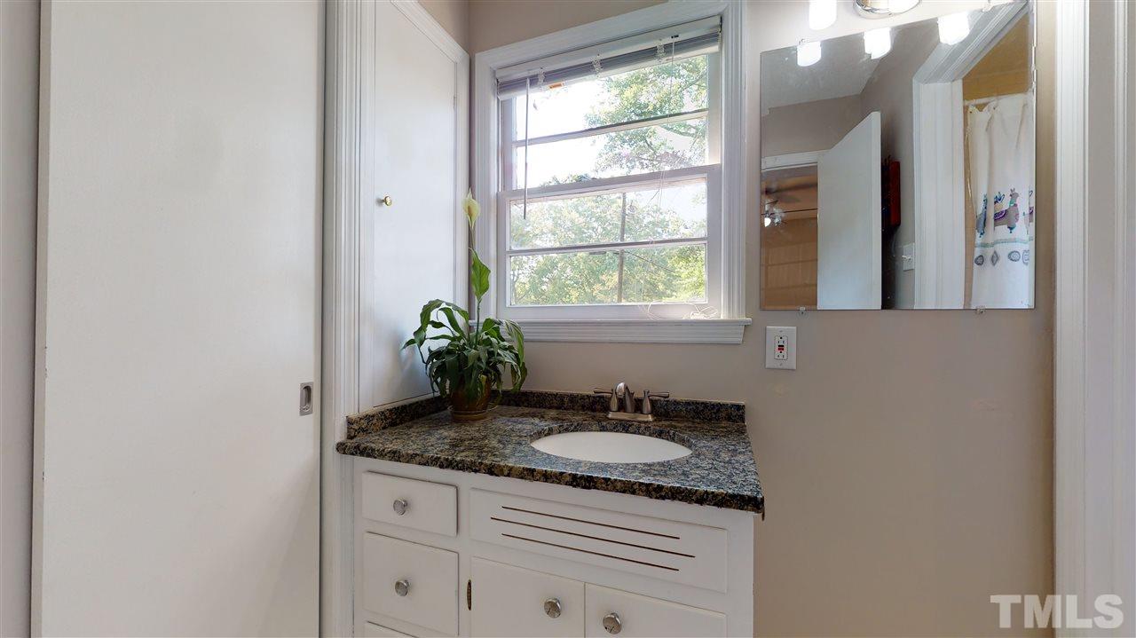 1001 Caspan Street Raleigh, NC 27610 - Photo 12 of 30 a bathroom with a granite countertop sink and a mirror
