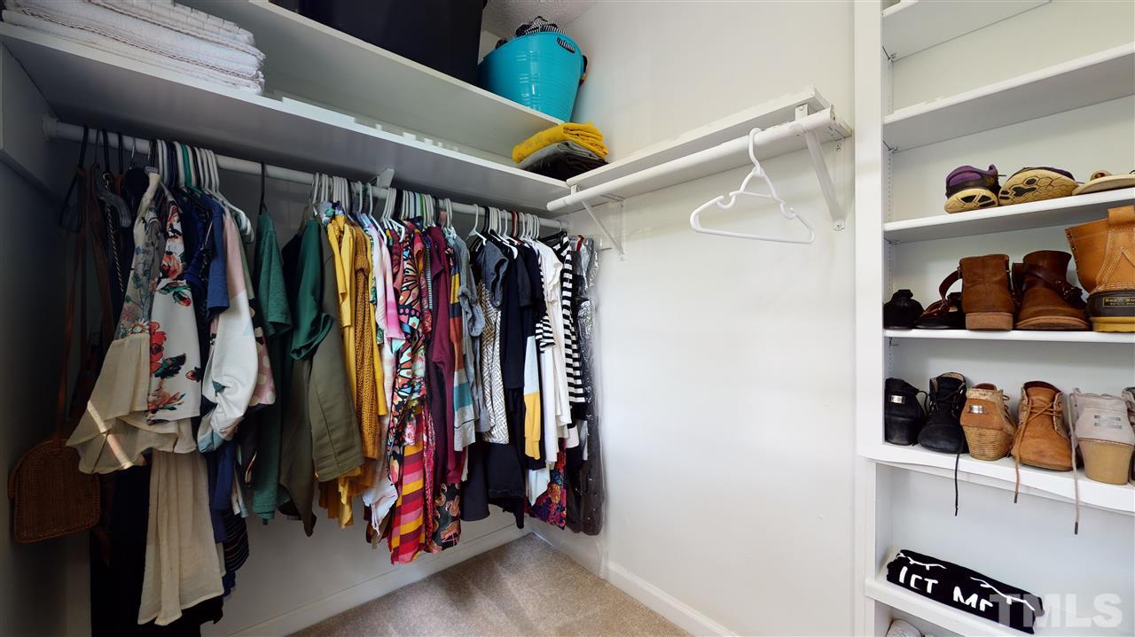 1001 Caspan Street Raleigh, NC 27610 - Photo 14 of 30 a view of walk in closet with clothes and shoes