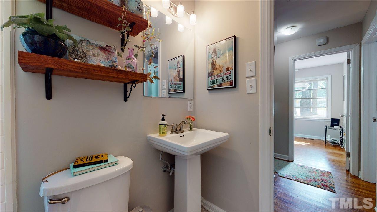 1001 Caspan Street Raleigh, NC 27610 - Photo 17 of 30 a bathroom with a sink a toilet and shower