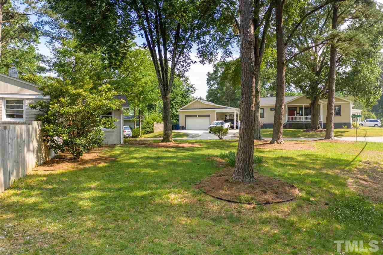 1001 Caspan Street Raleigh, NC 27610 - Photo 20 of 30 a view of a house with backyard and tree