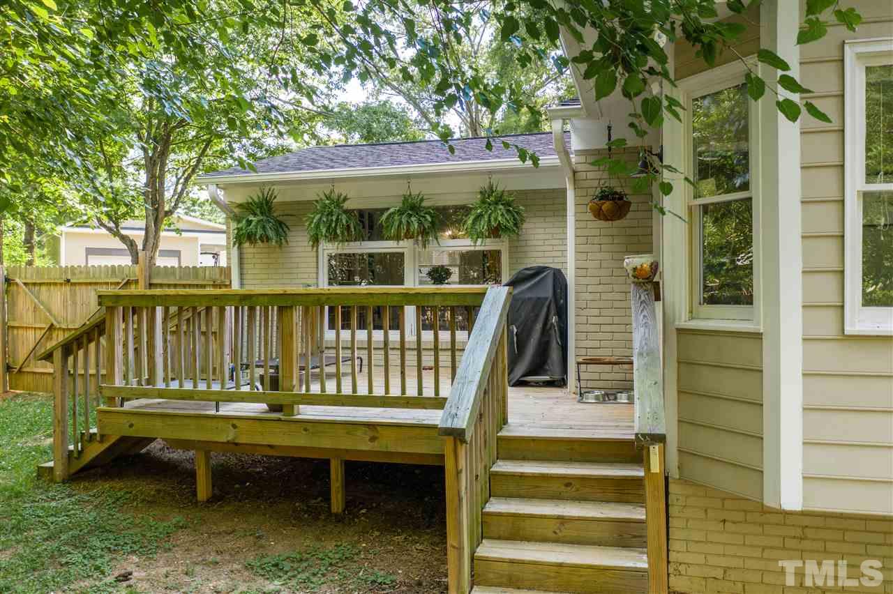 1001 Caspan Street Raleigh, NC 27610 - Photo 21 of 30 a view of a house with a wooden deck and furniture