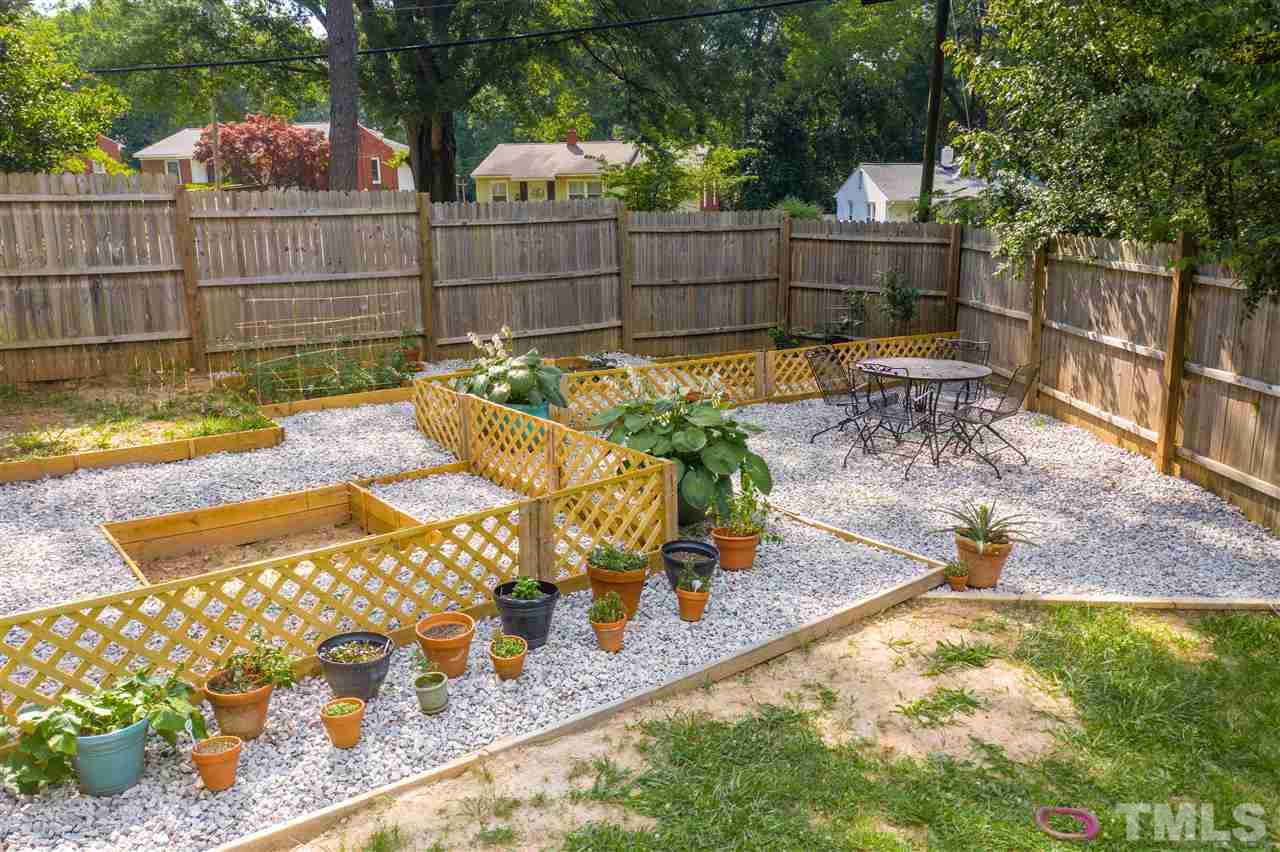 1001 Caspan Street Raleigh, NC 27610 - Photo 26 of 30 a view of a backyard with wooden fence