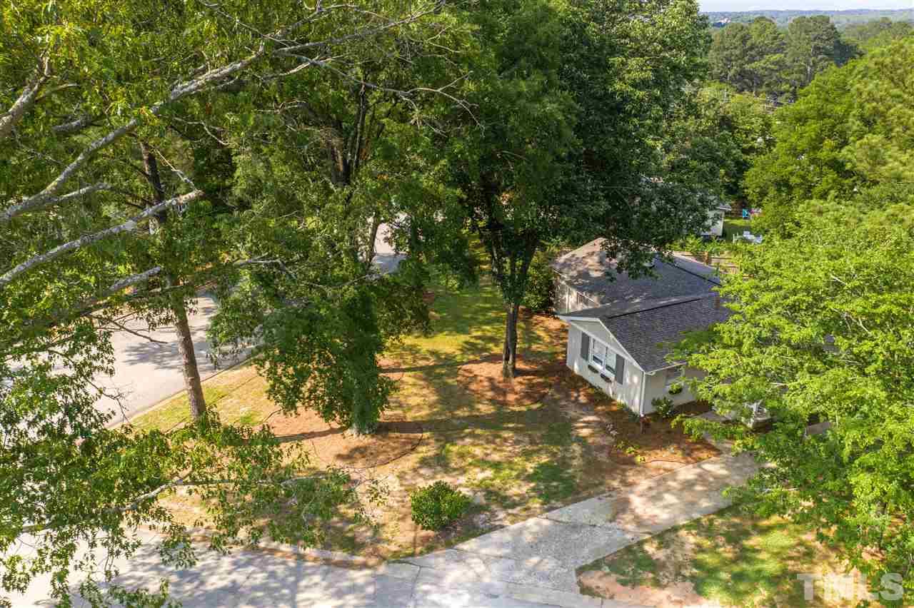1001 Caspan Street Raleigh, NC 27610 - Photo 27 of 30 a backyard of a house with large trees