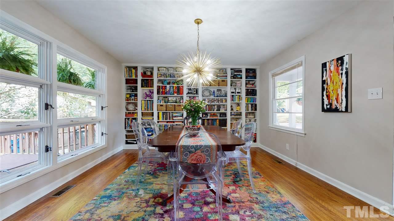 1001 Caspan Street Raleigh, NC 27610 - Photo 5 of 30 a front view of a livingroom with furniture wooden floor and windows