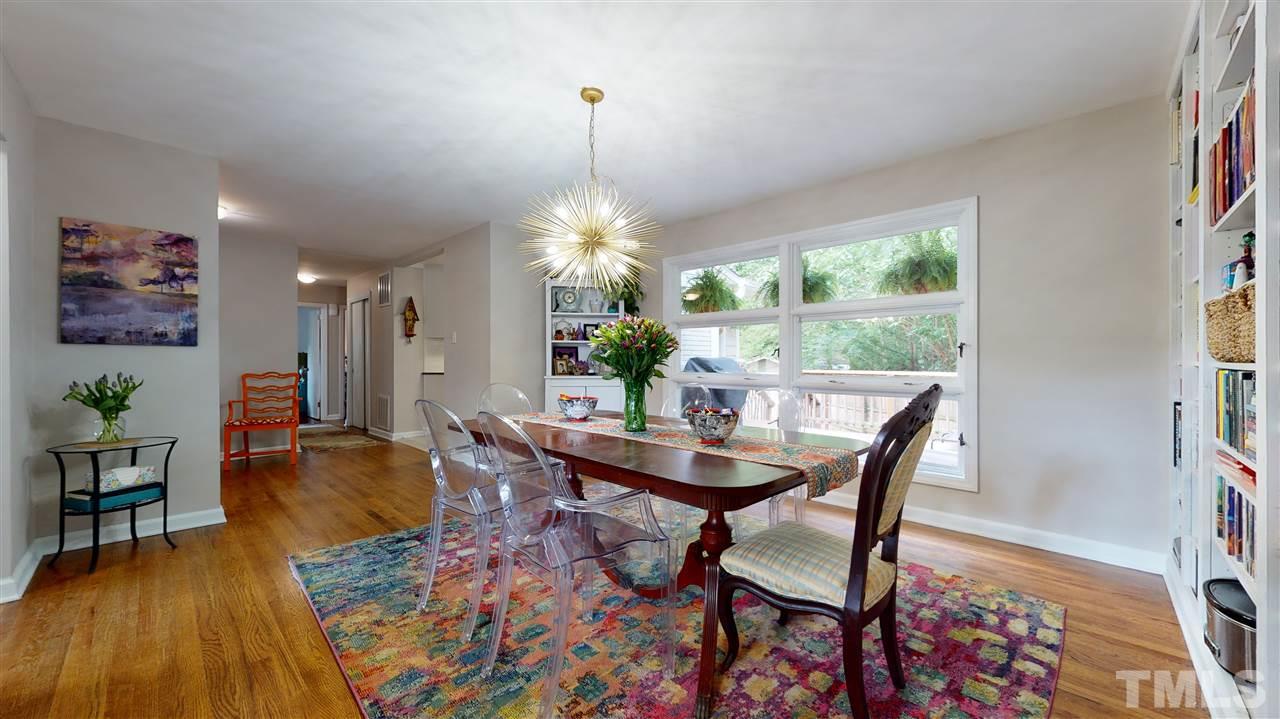1001 Caspan Street Raleigh, NC 27610 - Photo 6 of 30 a dining room with furniture a chandelier and wooden floor