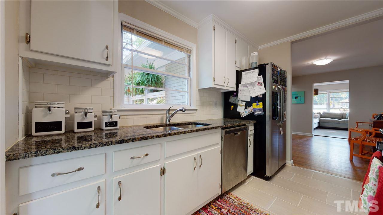 1001 Caspan Street Raleigh, NC 27610 - Photo 9 of 30 a kitchen with granite countertop a sink stainless steel appliances white cabinets and a window