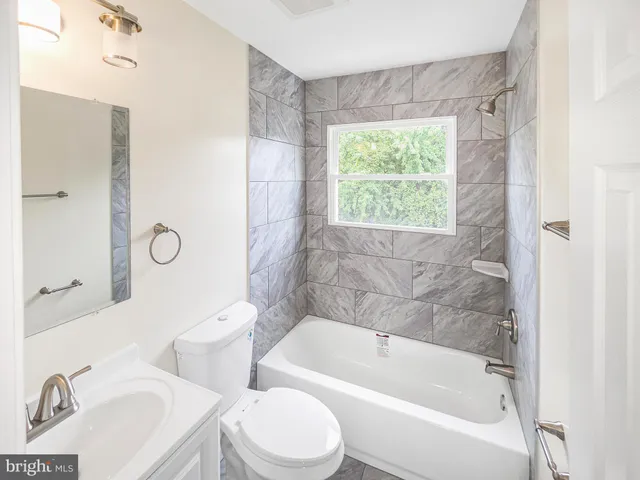 a bathroom with a sink toilet and bathtub