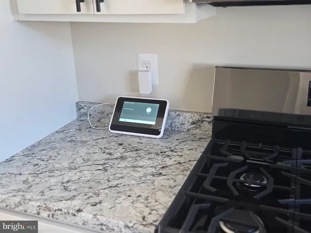 a stove top oven sitting inside of a kitchen