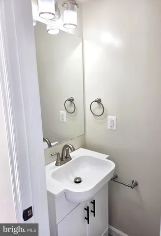 a bathroom with a sink a mirror and vanity