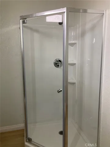 a bathroom with a glass shower door