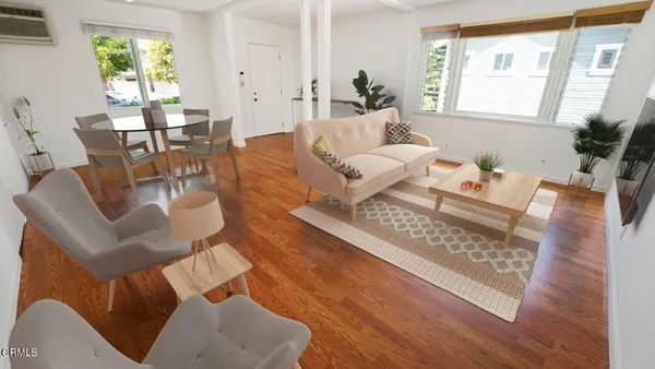 a living room with furniture rug and a large window
