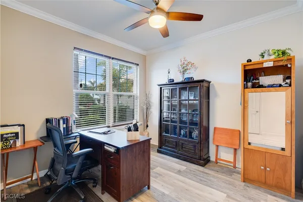 a view of a workspace with furniture and a window