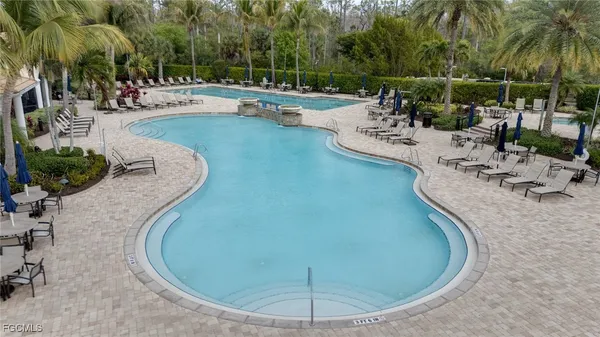 a view of a swimming pool with outdoor seating