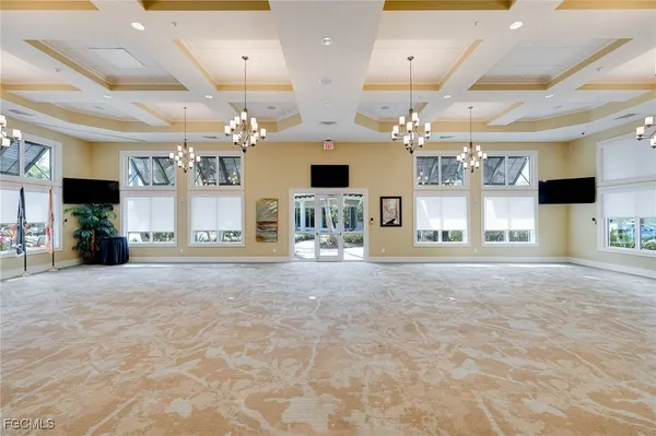 a view of a livingroom with a fireplace and a chandelier