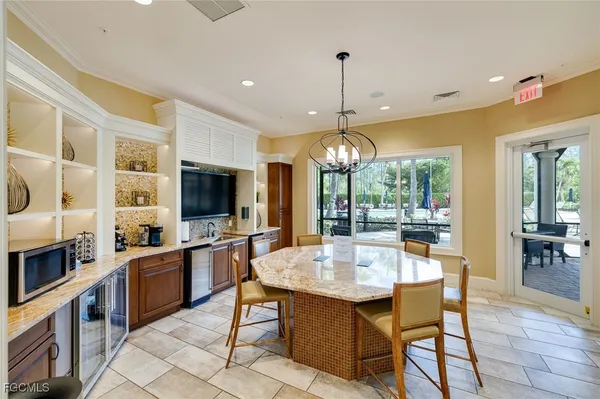 a large kitchen with a table and chairs