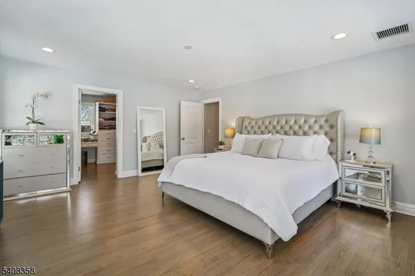 a bedroom with a bed and a view of kitchen