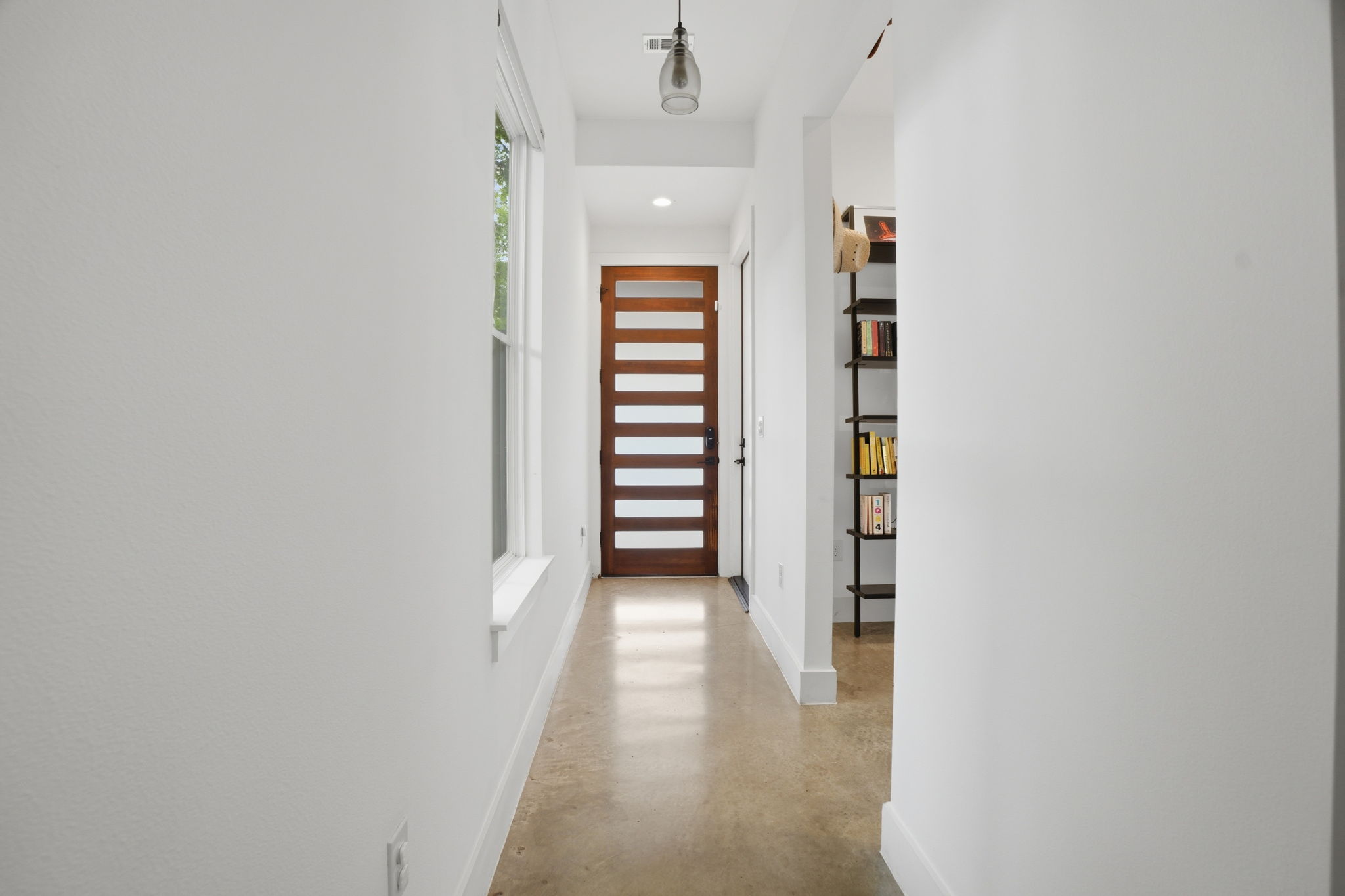 4609 Sara Drive, Unit B Austin, TX 78721 - Photo 7 of 39 Walk through this bright, modern hallway, illuminated by natural light and recessed fixtures.