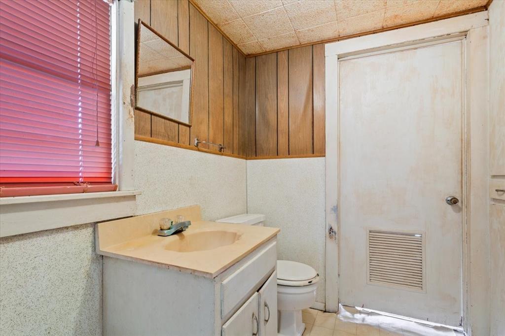 100 County Road 120 C Riesel, TX 76682 - Photo 18 of 25 Bathroom featuring vanity and wood walls