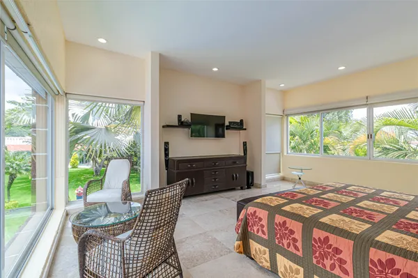 a bedroom with a bed and a large window