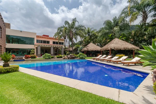 a swimming pool with outdoor seating and yard