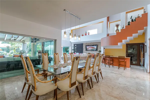 a view of a dining room with furniture and chandelier
