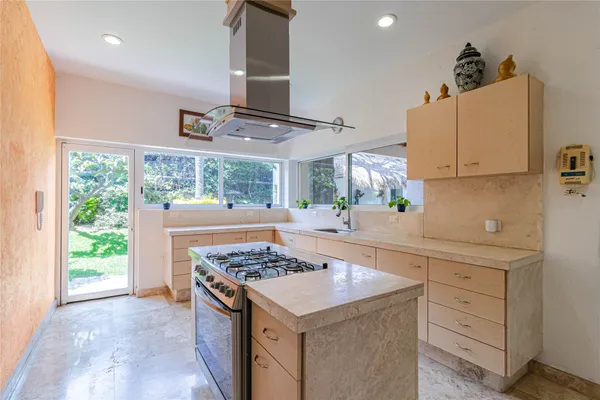 a kitchen with a sink stove and cabinets