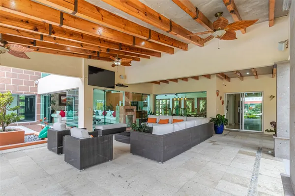 a living room with patio furniture and a large window