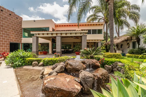 a view of a house with garden and porch